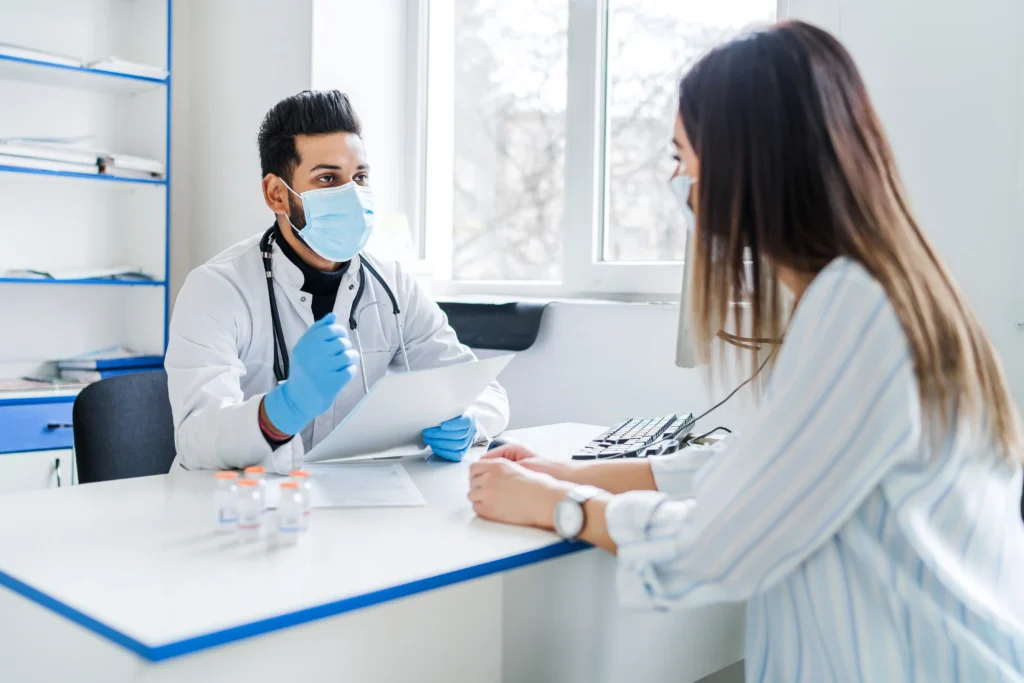 The image shows a patient consulting with a doctor when choosing the right SMP clinic in India.