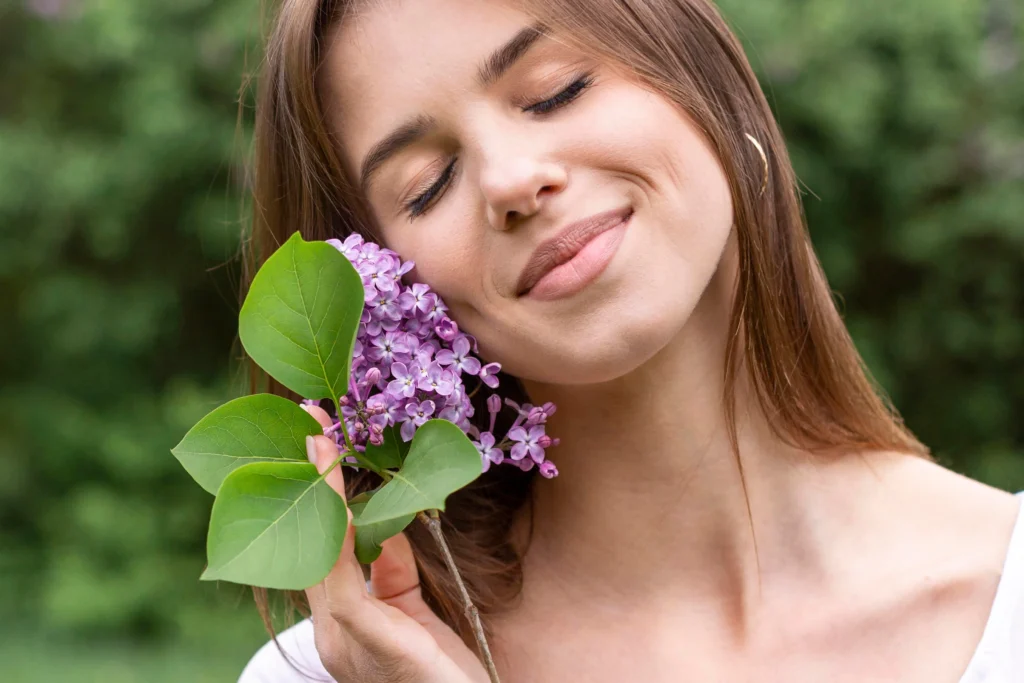 A woman with a serene expression and eyes closed, showcasing her natural-looking permanent makeup.