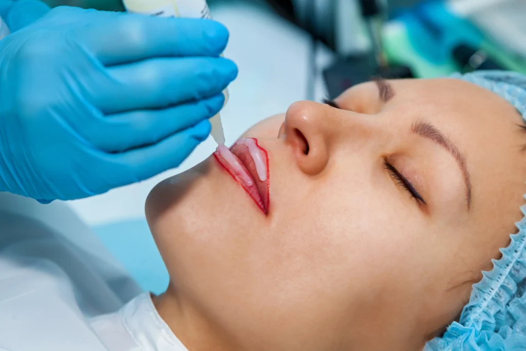 The image depicts a close-up of a microblading lips procedure.